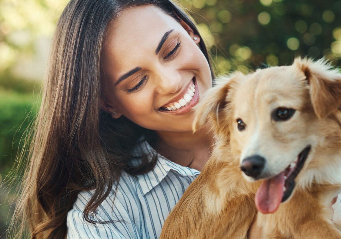 Woman Holding A Golden Retriever Puppy
